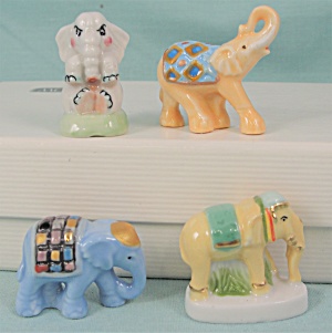 Tiny Herd Of Four Colorful Porcelain Elephants