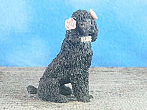 Sitting Black Poodle With Flowers